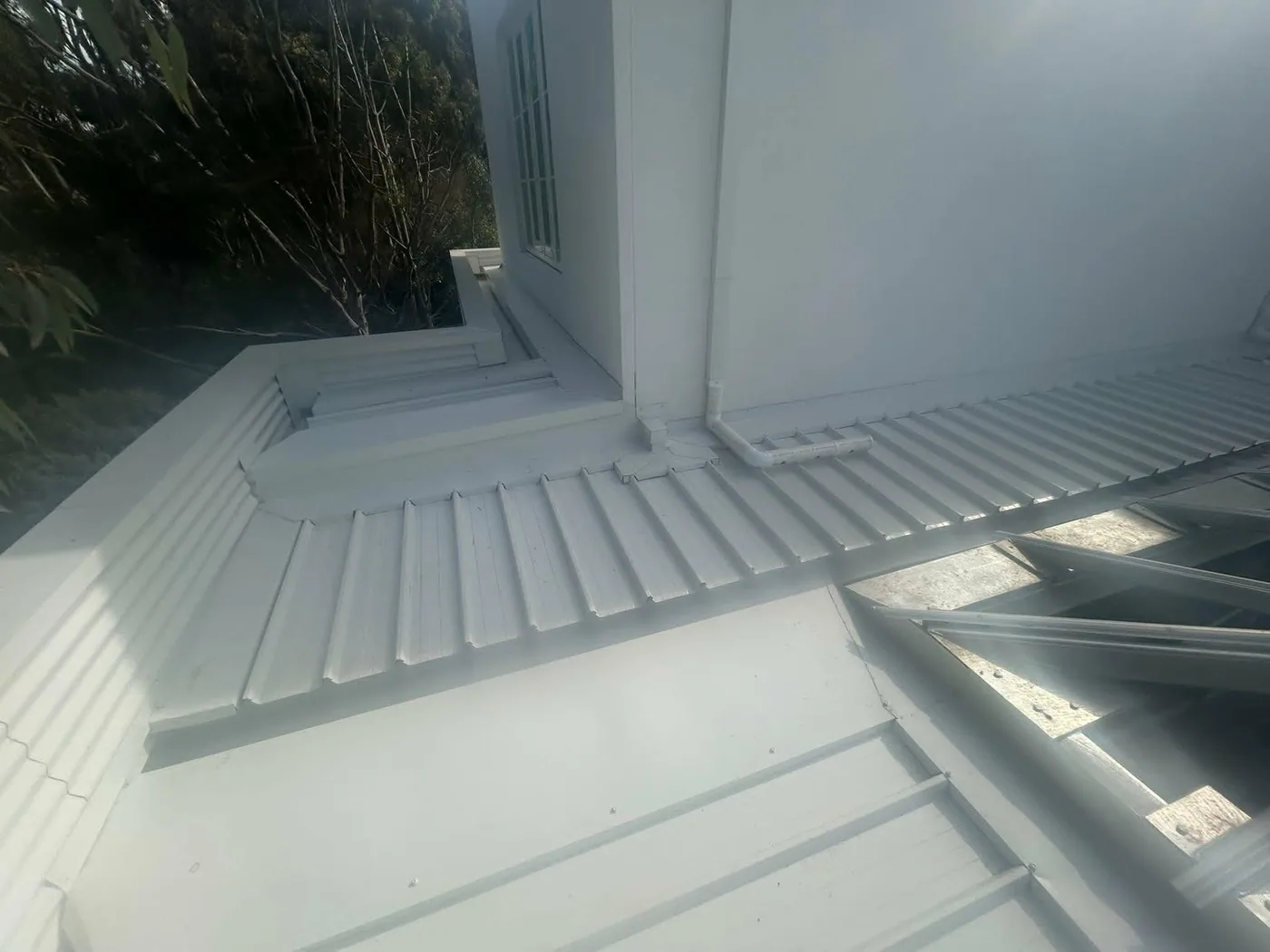 Clean Colorbond roof junction with downpipe detail